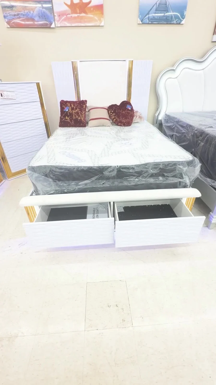 White and gold bed with two built-in storage drawers open
