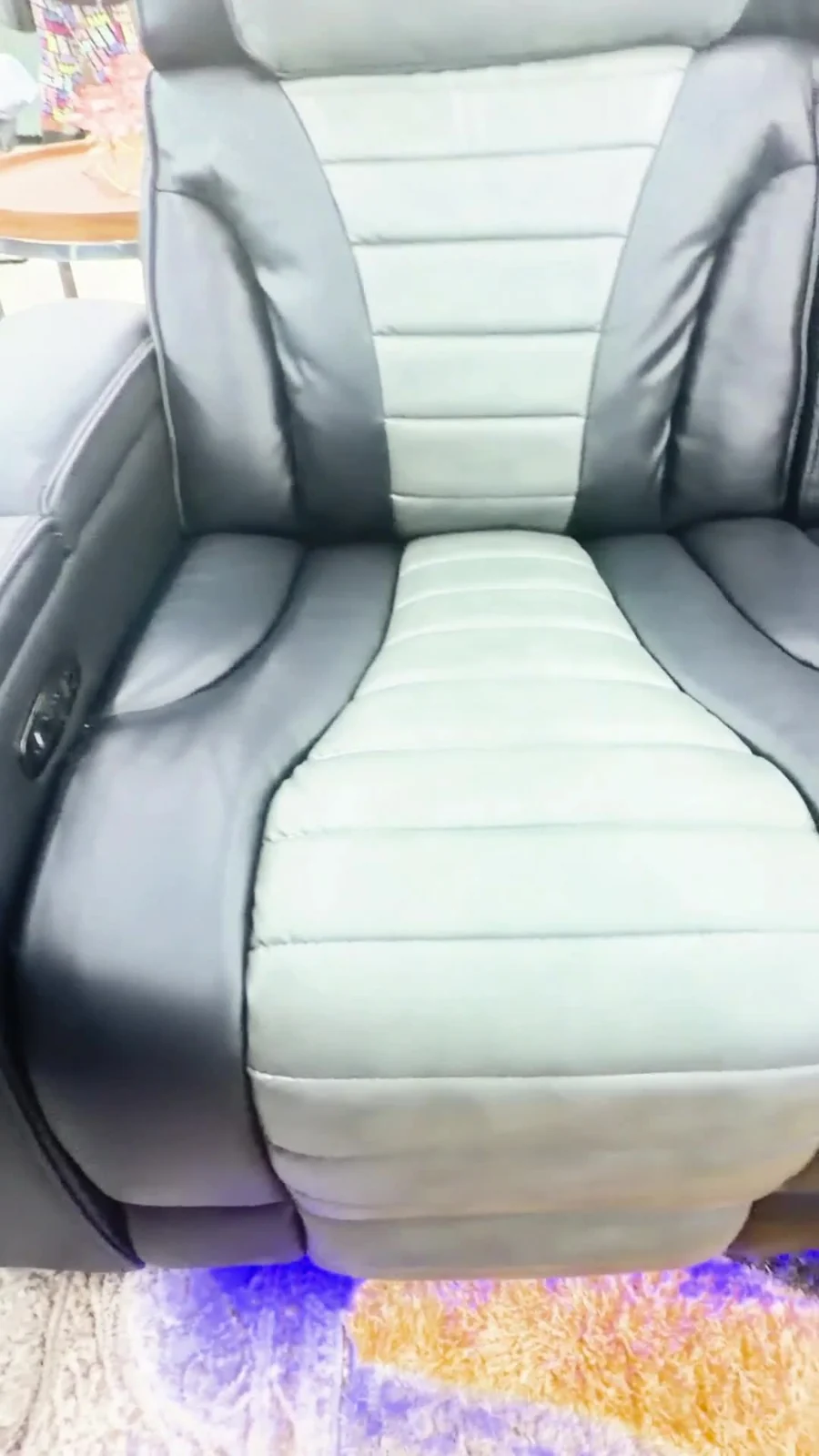 Black and light-gray reclining seating with blue accent lighting